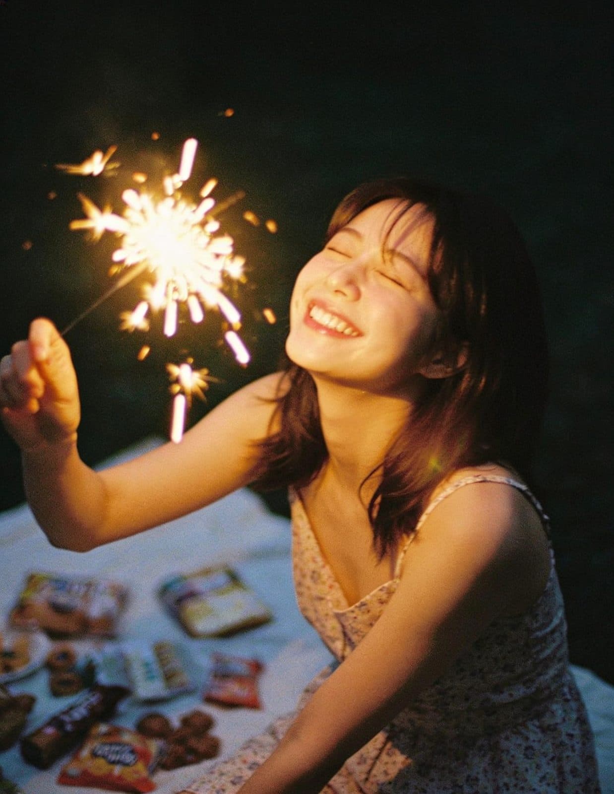 Mara holding a sparkler at dusk